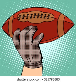 American football in his hand pop art retro style. Sports and Hobbies