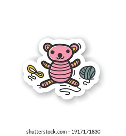 Amigurumi handmade sticker. Knitting a perfect teddy-bear, using needle pins and wool clew balls. Handmade badge for designs. Tenderly handmade crochet toy 