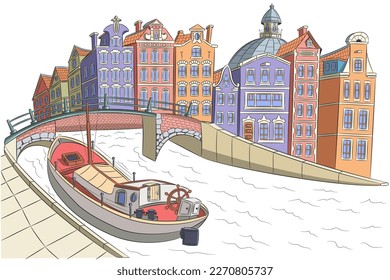 Amsterdam. An old cargo barge in a canal near the city embankment with colorful houses.