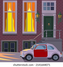 Amsterdam. Traditional brick house with a porch on the bank of the canal.