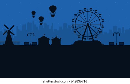 Amusement park at night scenery silhouettes