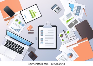 analysis financial graph business planning management concept top angle view desktop laptop smartphone checklist paper documents report office stuff horizontal