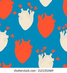 Anatomical heart vector seamless pattern on blue background. Heart with arrows