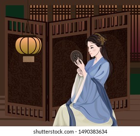 Ancient Chinese woman sitting make up in the mirror in front of the partition