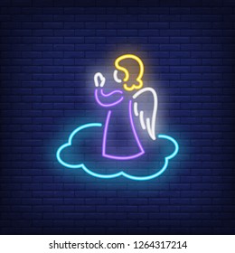 Angel praying on cloud neon sign. Christmas or Easter design element. Night bright neon sign, colorful billboard, light banner. Vector illustration in neon style.