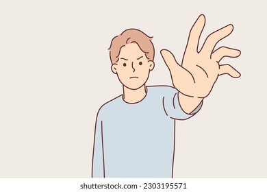 Angry man reaches out to screen in attempt to take something away from you or to stop harmful actions. Angry guy makes stop gesture feeling anger and negativity due to wrong actions of opponent