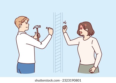 Angry woman knocks on wall swearing at neighbor is doing repairs in apartment and using hammer. Nervous girl quarreling with neighbor hammering nails because of noise caused by renovation
