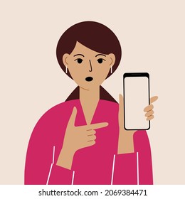 Angry woman with mobile phone, front view. Indicates the phone. News. Smartphone and internet addiction.