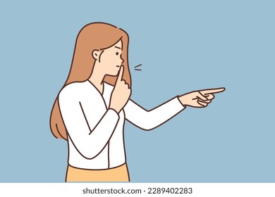 Angry woman puts finger to lips to urge quiet and not make noise during important meeting or school lesson. Nervous girl makes shh gesture and points to side ordering to observe quiet