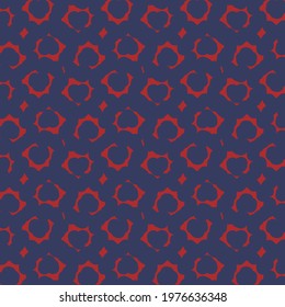 Angular  broken rings and other small fragments, colored in red, arranged on a blue background. Wrapping paper.