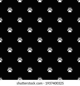 Patrón sin fisuras de huellas de animales. Paws sobre un fondo negro. Impresión de vectores