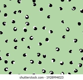 Animal print hand drawing with dots on green background for fabric.