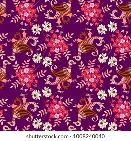 Animal seamless ornament in ethnic style. Magic birds with wings in paisley shape and beautiful flowers on dark purple background.