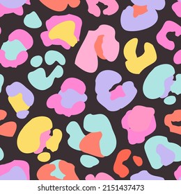 Animal skin print in rainbow colors, 90s style. Colorful leopard spot seamless pattern design. Abstract blob, rosettes texture. Bold summer vector illustration for surface wrapping, fun fabric design