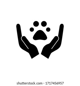 Animals help black silhouette vector illustration isolated on white background. Animal footprint, trace in hands. Voluntary, charity, donation icon.
