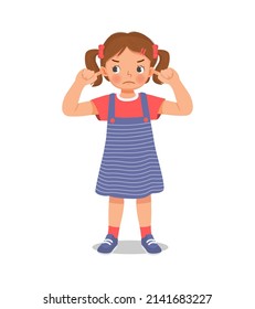 annoyed little girl not listening plugging and covering her ears with fingers from loud noisy sound showing annoyed facial expression