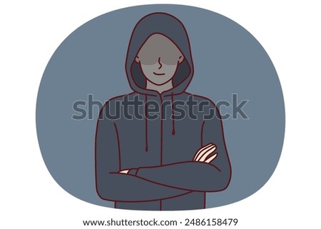 Anonymous man stands with arms crossed and hiding eyes behind hood for concept of secret surveillance or banditry. Anonymous guy hiding face wanting to remain incognito planning illegal activities
