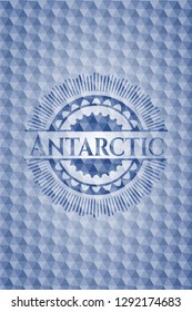 Antarctic blue emblem with geometric pattern background.