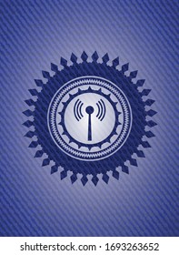 antenna signal icon inside badge with denim background