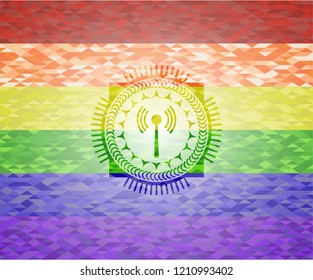 antenna signal icon inside emblem on mosaic background with the colors of the LGBT flag