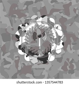 antenna signal icon inside grey camouflaged emblem