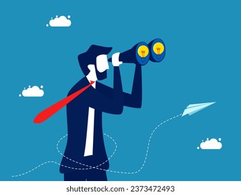 Anticipate the future with knowledge. Businessman uses binoculars to look at a light bulb
