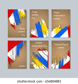 Antigua Patriotic Cards for National Day. Expressive Brush Stroke in National Flag Colors on kraft paper background. Antigua Patriotic Vector Greeting Card.