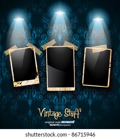 Antique distressed photoframes with old dirty look on a vintage seamless wallpaper. Frames are featured by led spotlights.Shadows are transparent.
