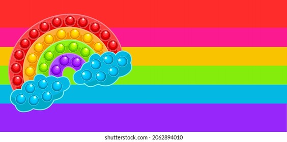 An anti-stress game, in the form of a cute rainbow-shaped toy. Handmade toy in rainbow colors and on a rainbow background. Pop it. Simple Dimple.
