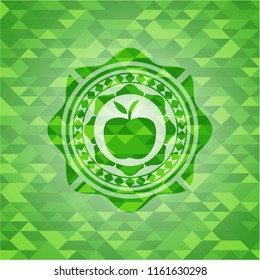 apple icon inside green emblem with triangle mosaic background