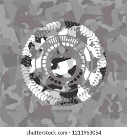 apple icon inside grey camouflaged emblem