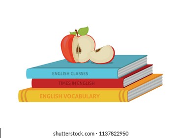 Apple lying on books for learning English.