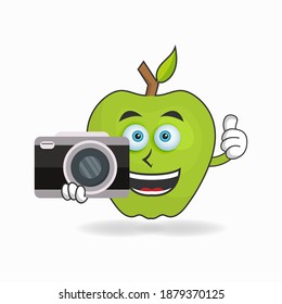 Apple mascot character holding camera. vector illustration