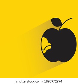 apple with shadow on yellow background