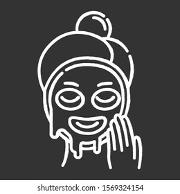 Applying liquid mask chalk icon. Skin care procedure. Facial beauty treatment. Face product for lifting and exfoliating effect. Dermatology, cosmetics, makeup. Isolated vector chalkboard illustration