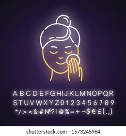 Applying moisturizer neon light icon. Skincare procedure. Cleansing effect for healthy skin. Makeup removal. Dermatology. Glowing sign with alphabet, numbers and symbols. Vector isolated illustration