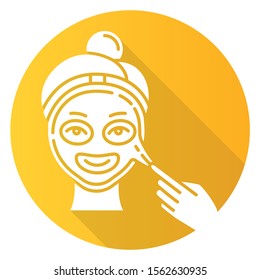 Applying peel-off mask yellow flat design long shadow glyph icon. Skin care procedure. Facial beauty treatment. Face product for lifting and exfoliating effect. Vector silhouette illustration