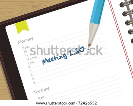 appointment book with clipping mask and pen on wood background