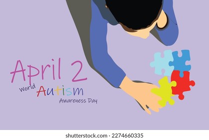 April 2 - World autism awareness day heading. A little Autistic boy staring and playing at colorful ASD symbol puzzles with graphic wording Love, Accept, Understand overlay on it. Mental, Top view