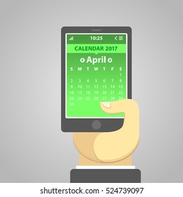April 2017, weeks start from Sunday. Simple UI in flat design. Vector illustration of a smartphone holding in a hand, with a calendar on the screen.  