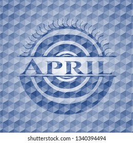 April blue badge with geometric background.
