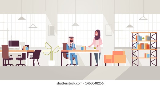 arab businessman with female assistant using laptop discussing new project during meeting at workplace teamwork concept creative workspace modern office interior flat full length horizontal