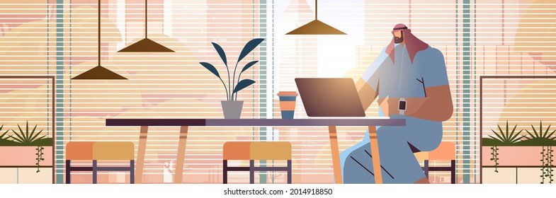 arab businessman sitting at workplace arabic business man freelancer working in creative office horizontal