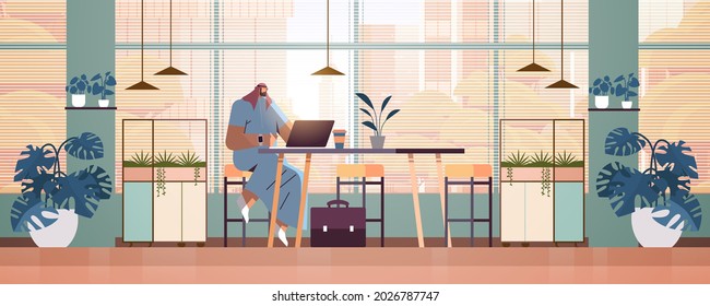 arab businessman sitting at workplace arabic business man freelancer working in creative office horizontal