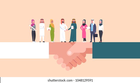 Arab Businessmen Shaking Hands With Team Of Muslim Businesspeople, Business Agreement And Partnership Concept