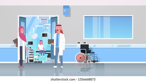 arab doctors discussing in hospital corridor with wheelchair open door to surgery room arabic man sitting operating table modern clinic interior flat full length horizontal banner