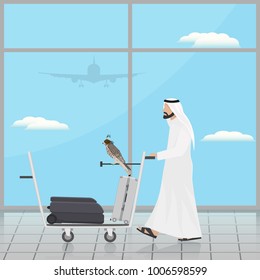 Arab with a falcon on a trolley at the airport