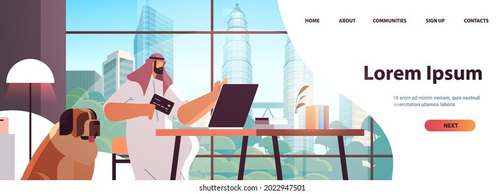 arab man with credit card using laptop online shopping concept living room interior horizontal