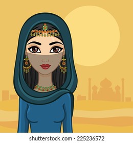 Arab princess against a tower in the desert.