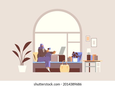 arab woman with credit card using laptop online shopping concept living room interior horizontal